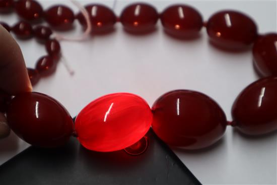 A single strand graduated simulated cherry amber necklace, gross weight 95 grams,